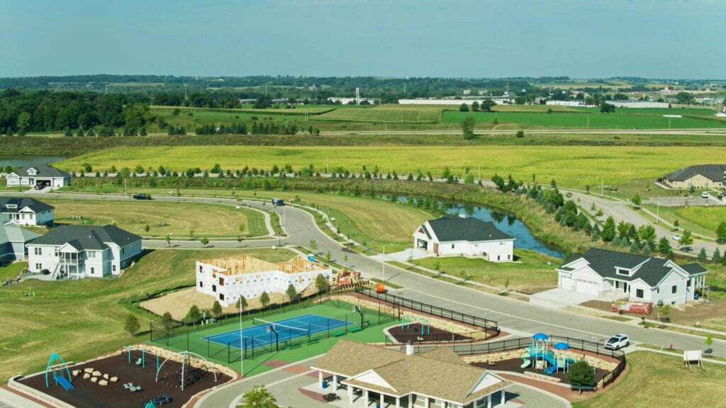 River Flowing Past Suburb Under Development - Aerial