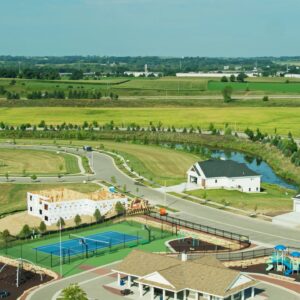 River Flowing Past Suburb Under Development - Aerial